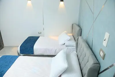 a hotel room with two beds and a couch at Crystala guest house in Aswan