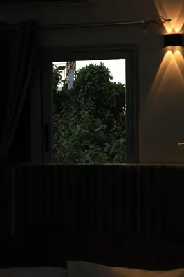 a mirror in a bedroom looking at a window at Crystala guest house in Aswan