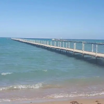 a pier stretches out into the ocean with a beach at Fox Resort El Gouna Stay in Hurghada