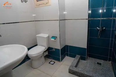 a bathroom with a toilet and a sink and a shower at Fox Resort El Gouna Stay in Hurghada