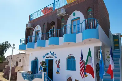 a building with a balcony on top of it at Nubian Popeye - Roof top - Nile View in Aswan