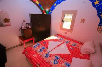 a bedroom with a bed with a envelope on it at Nubian Popeye - Roof top - Nile View in Aswan