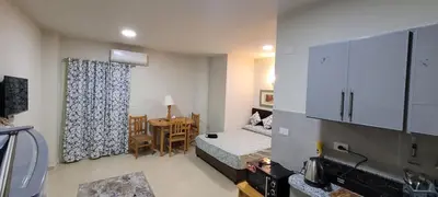 a bedroom with a bed and a table with a table at Hotel Room in Princess Resort With Beach Acces & Free Wi-fi I Near Air port in Hurghada