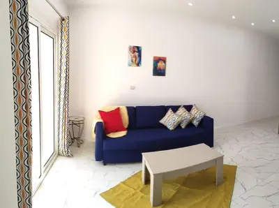 a living room with a blue couch and a coffee table at Condo with Breathtaking 's view with 2 bedrooms in Hurghada