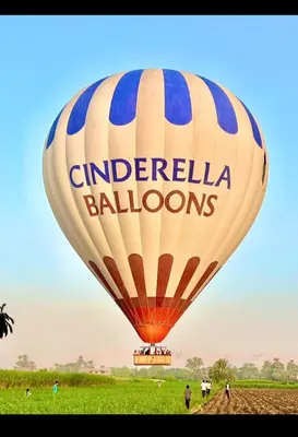 a large hot air balloon flying over a field at Quiet Gate Guest House in Al Aqālitah