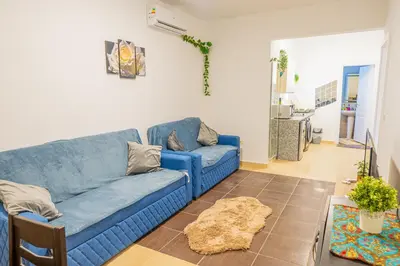 a living room with a blue couch and a table at Go Egypt Apartments Inside Karma Beach Resort North Al Ahiaa , Hurghada in Hurghada