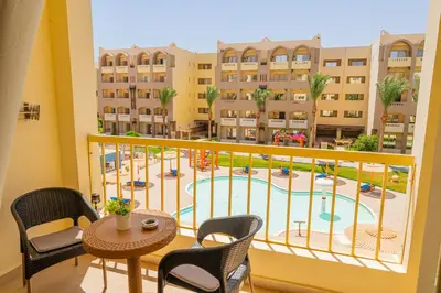 a balcony with a view of a pool at Go Egypt Apartments Inside Karma Beach Resort North Al Ahiaa , Hurghada in Hurghada