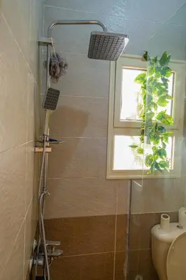 a shower in a bathroom with a window at Go Egypt Apartments Inside Karma Beach Resort North Al Ahiaa , Hurghada in Hurghada