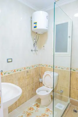 a bathroom with a toilet and a sink and a shower at Go Egypt Apartments Inside Karma Beach Resort North Al Ahiaa , Hurghada in Hurghada