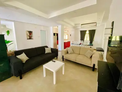 a living room with a couch and a table at villa 5 in magawish in Hurghada