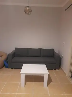 a living room with a couch and a white coffee table at Alfayrouz house in Hurghada