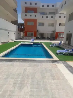 a swimming pool in the middle of a building at Alfayrouz house in Hurghada