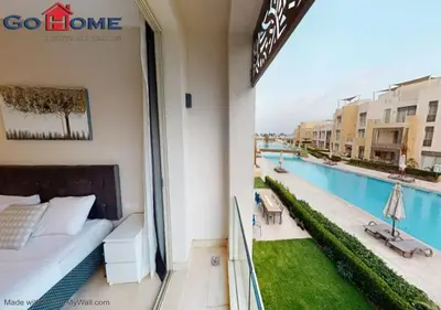 a balcony of a hotel with a bed and a swimming pool at Stylish 1BR @ Mangroovy-M7-6B in Hurghada