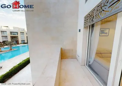 a room with a view of the pool in a building at Stylish 1BR @ Mangroovy-M7-6B in Hurghada
