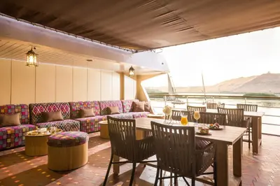 a restaurant with a table and chairs and a couch at M/Y ALYSSA - 4 or 7 Nights From Luxor each Monday and 3 or 7 Nights From Aswan each Friday in Luxor