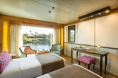 a room with a bed and a desk and a window at M/Y ALYSSA - 4 or 7 Nights From Luxor each Monday and 3 or 7 Nights From Aswan each Friday in Luxor