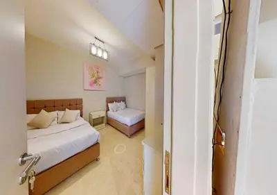 a bedroom with a bed and a room with two beds at Beautiful 2 Bed Rooms at Mangaroveey M7-4B-El-Gouna in Hurghada