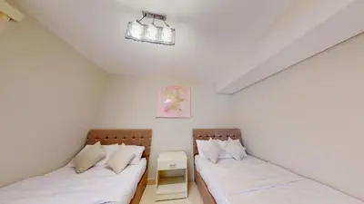 two beds in a room with white walls at Beautiful 2 Bed Rooms at Mangaroveey M7-4B-El-Gouna in Hurghada