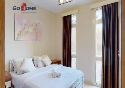 a bedroom with a white bed and windows at Beautiful 2 Bed Rooms at Mangaroveey M7-4B-El-Gouna in Hurghada