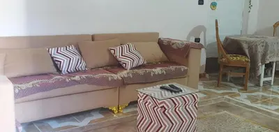 a living room with a couch and a table at Seashell in Quseir