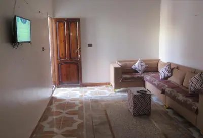 a living room with a couch and a television at Seashell in Quseir