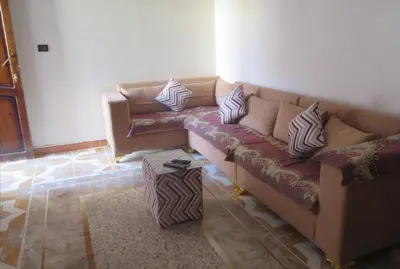 a living room with a couch with pillows on it at Seashell in Quseir
