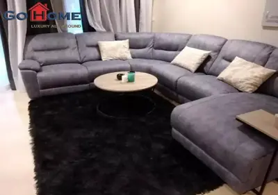 a living room with a blue couch and a table at Warm 1BR with @ Mangroovy, El-Gouna M1-7B in Hurghada