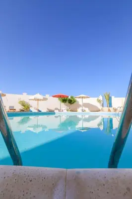 a view of a swimming pool with umbrellas at La BONITA FLAT in Hurghada
