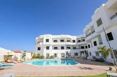 an apartment with a swimming pool in front of a building at La BONITA FLAT in Hurghada