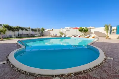 a large swimming pool with blue water at La BONITA FLAT in Hurghada