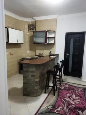 a kitchen with a bar in the middle of a room at Hurghada city Apartment 4 in Hurghada