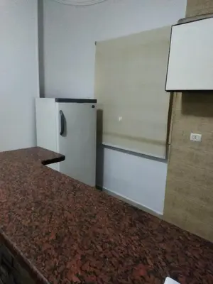 a kitchen with a refrigerator and a counter top at Hurghada city Apartment 4 in Hurghada