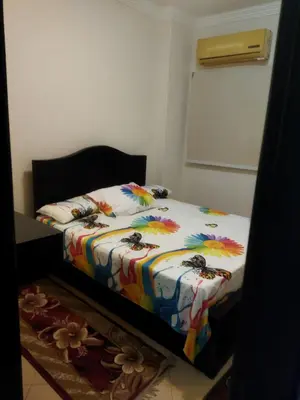 a bedroom with a bed with a comforter with bees on it at Hurghada city Apartment 4 in Hurghada