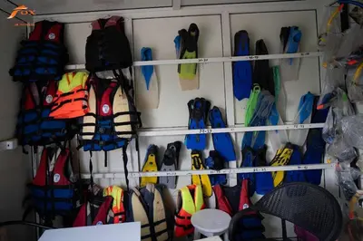 a bunch of umbrellas are hanging on a wall at Fox Beach Stay in Hurghada