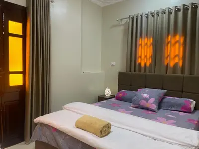 a bedroom with a bed with purple and pink pillows at White Star House in Safaga