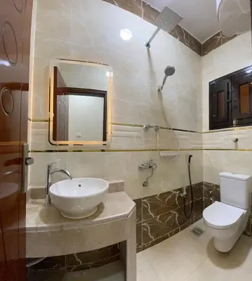 a bathroom with a sink and a toilet and a mirror at White Star House in Safaga