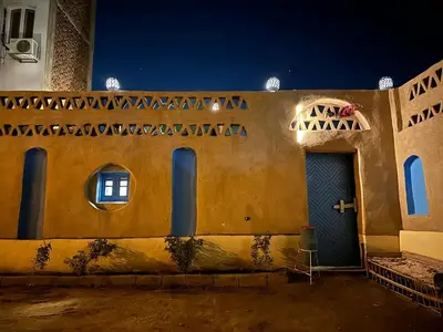 a building with a blue door and windows at night at Villa Rebecca Professor's paradise in Luxor