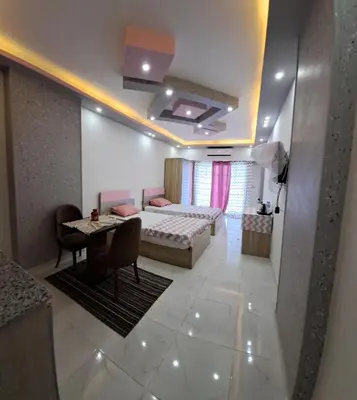 a bedroom with a bed and a table in a room at Juliana beach resort in el ahead st in El Gouna