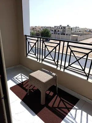 a balcony with a table and a view of a city at Juliana beach resort in el ahead st in El Gouna