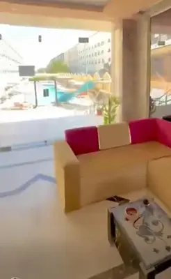 a living room with a couch and a table at Fox House Resort Apartment in Hurghada
