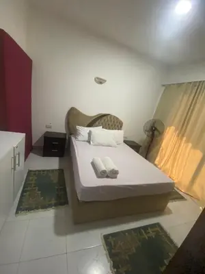a bedroom with a bed with two towels on it at Fox house resort Apartment hotel in Hurghada