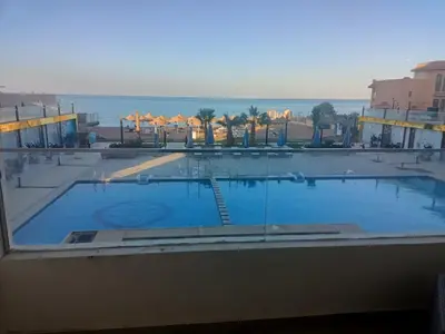 a large swimming pool with a view of the ocean at Casablanca star Beach Hurghada كازابلانكا ستار بيتش الغردقة in Hurghada