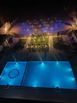 an overhead view of a swimming pool at night at Casablanca star Beach Hurghada كازابلانكا ستار بيتش الغردقة in Hurghada