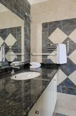 a bathroom with a sink and a mirror at White Villa with open lagoon view in Hurghada