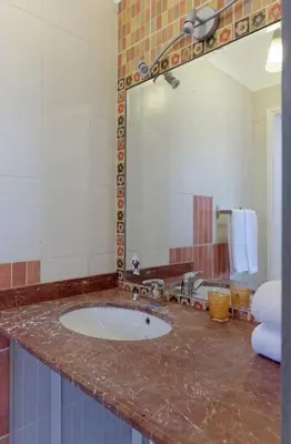 a bathroom counter with a sink and a mirror at White Villa with open lagoon view in Hurghada