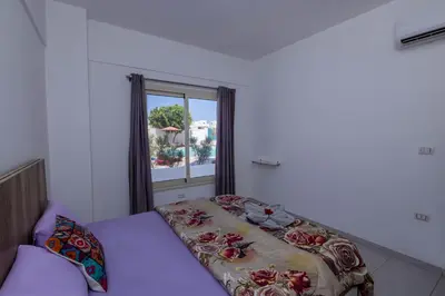 a small bedroom with a bed and a window at La bonita studio b1 in Hurghada