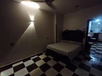 a bedroom with a bed and a checkered floor at Couple's Cove in Luxor