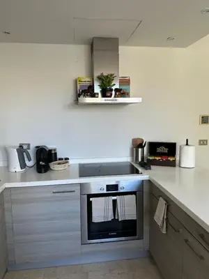 a kitchen with a stove top oven in a kitchen at Bright & Lovely 2 Beds Apartment in Scarab Club, El Gouna in Hurghada