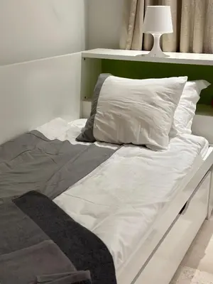 an unmade bed with white sheets and a pillow at Bright & Lovely 2 Beds Apartment in Scarab Club, El Gouna in Hurghada