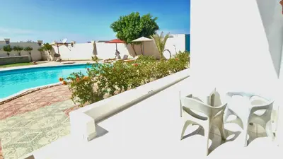 a villa with a swimming pool and a house at La bonita studio in Hurghada